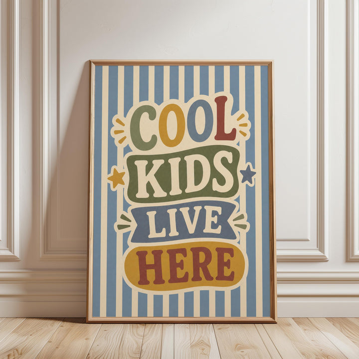 A framed poster with the text "COOL KIDS LIVE HERE" in a colorful, vintage-style design.