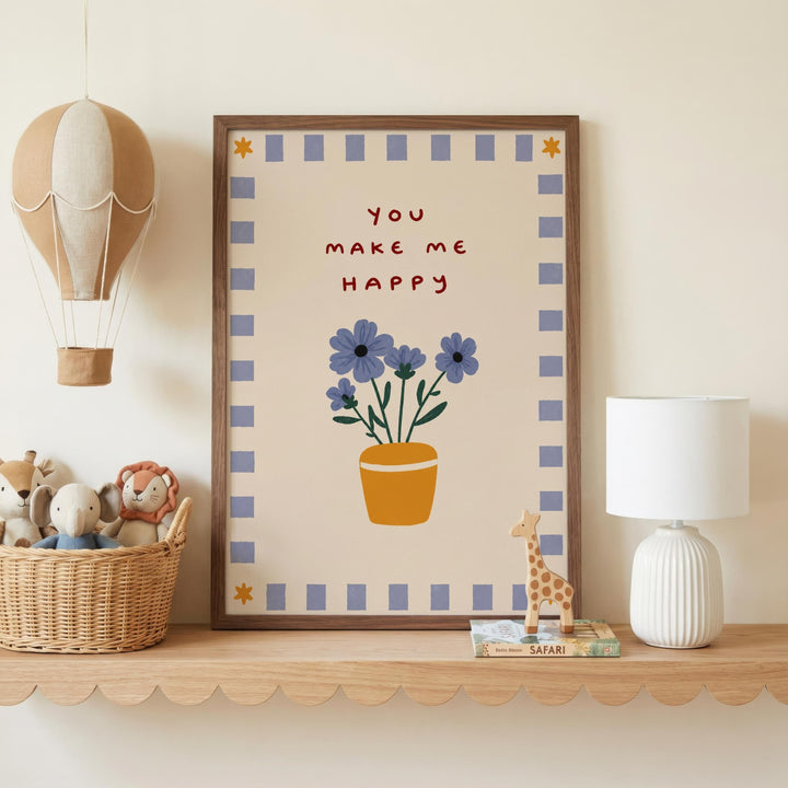 a framed poster with a floral design and the text "You make me happy" on a shelf, surrounded by toys and a lamp.