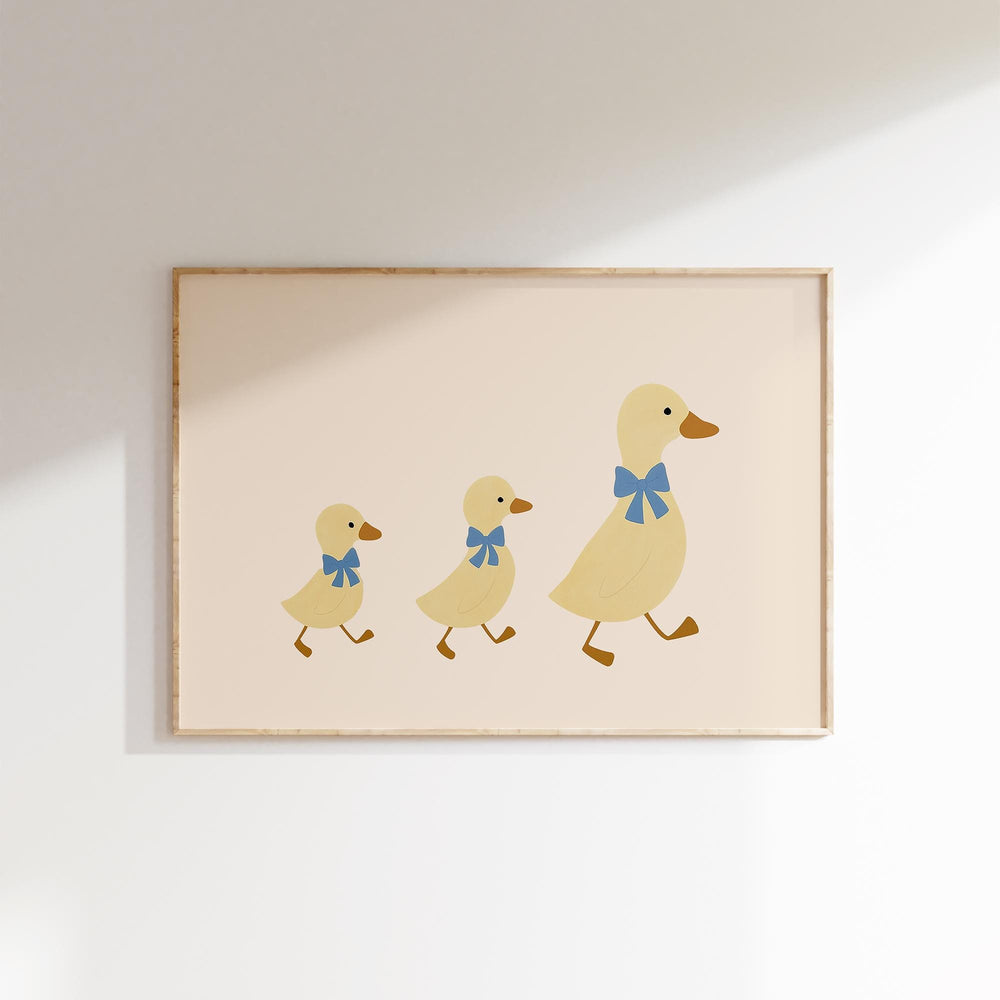 a picture of three ducklings with a blue bow