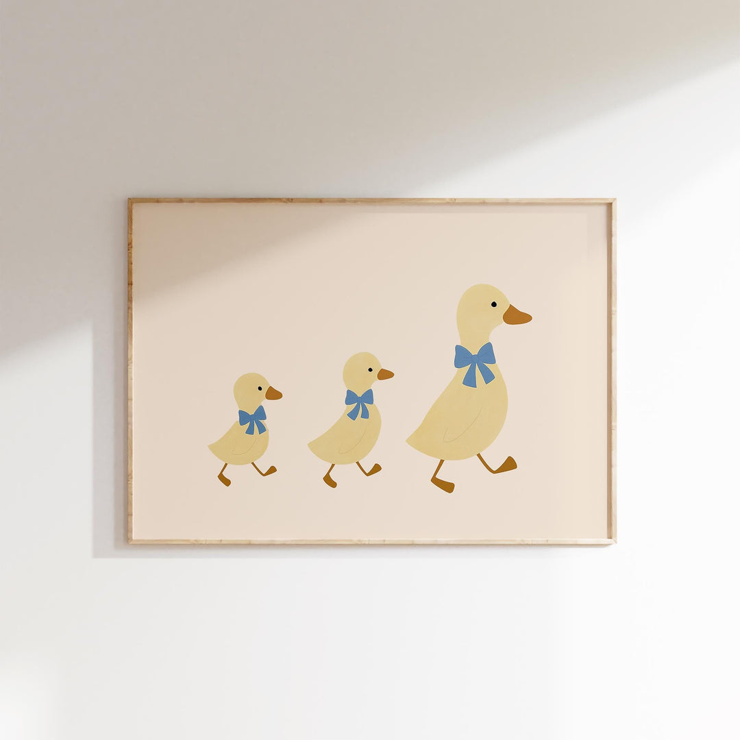 a picture of three ducklings with a blue bow