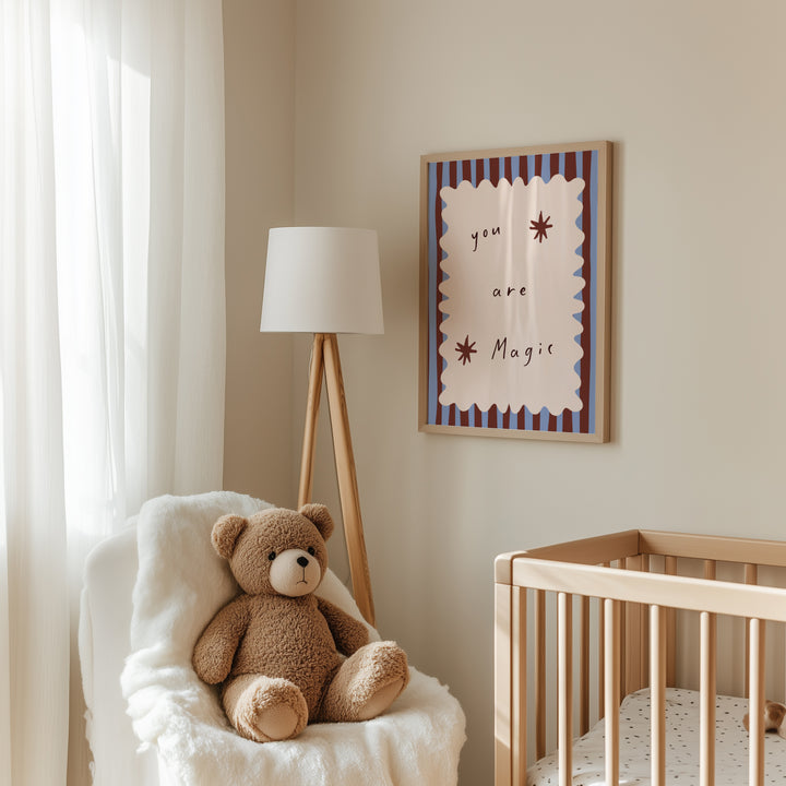 a teddy bear sitting in a chair next to a crib