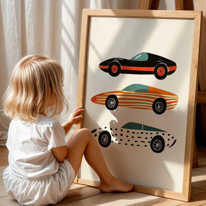 a little girl sitting on the floor next to a picture
