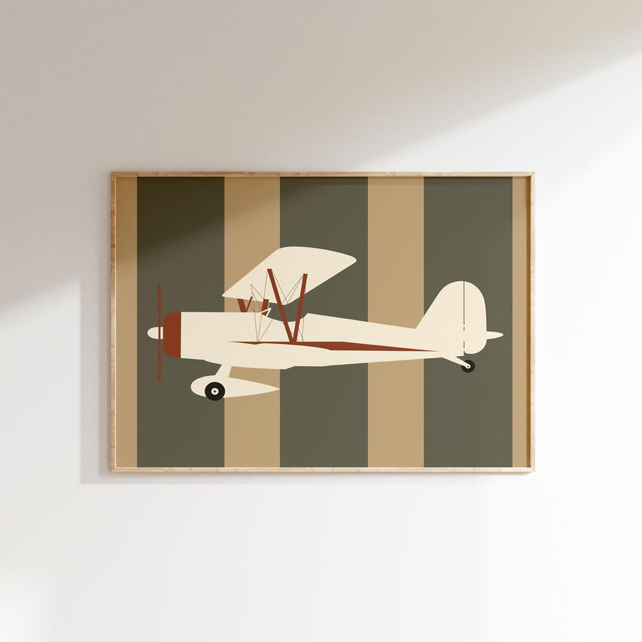 a picture of a small airplane hanging on a wall