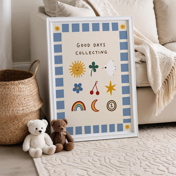 A framed poster with the text "Good Days Collecting" is displayed on a beige couch, accompanied by two stuffed teddy bears sitting on the floor.