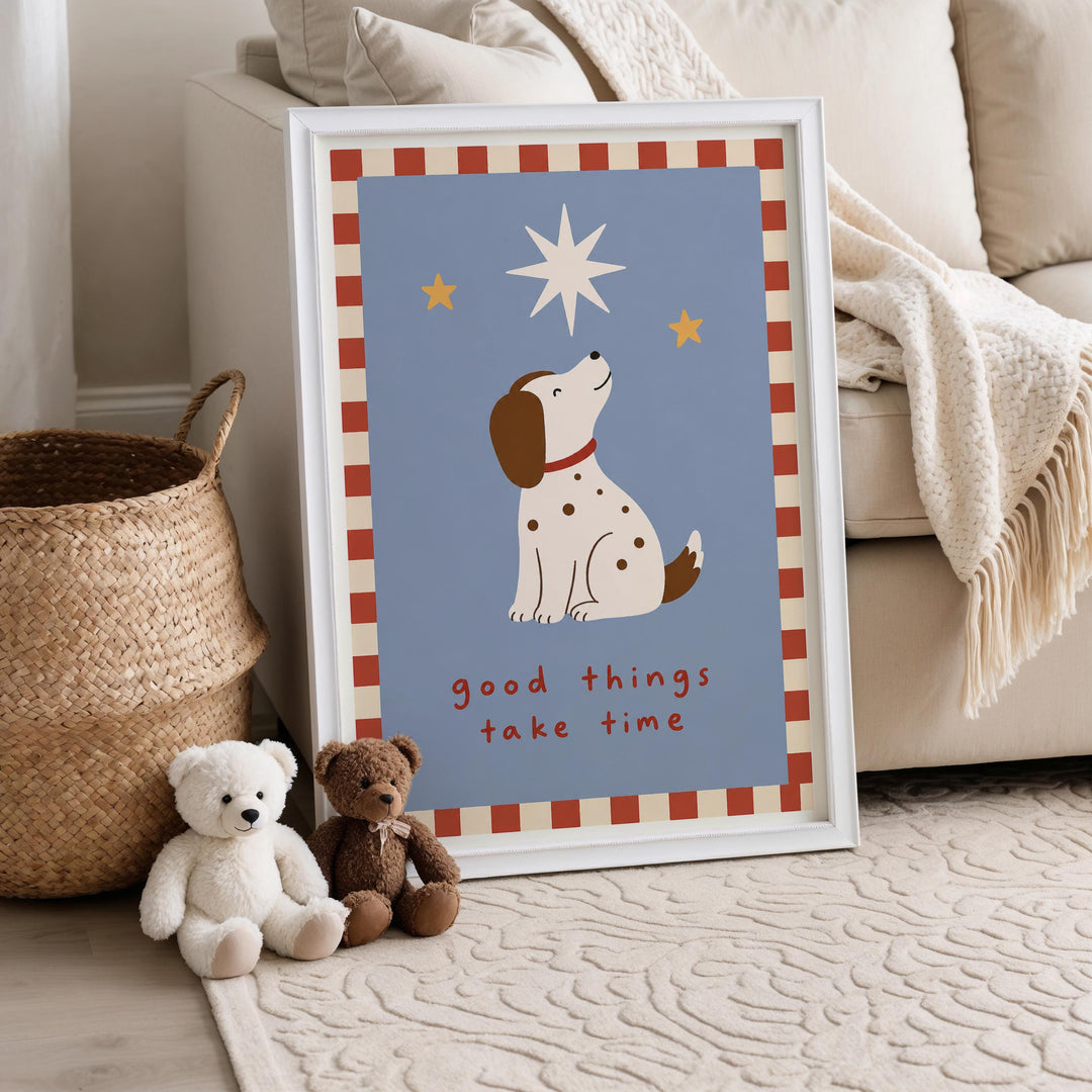 A framed poster with a cartoon dog and a star, placed on a beige rug next to a white basket and two stuffed animals.