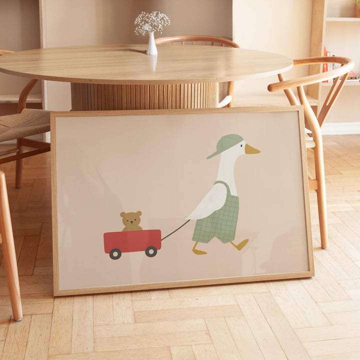 a picture of a duck pulling a teddy bear on a wagon