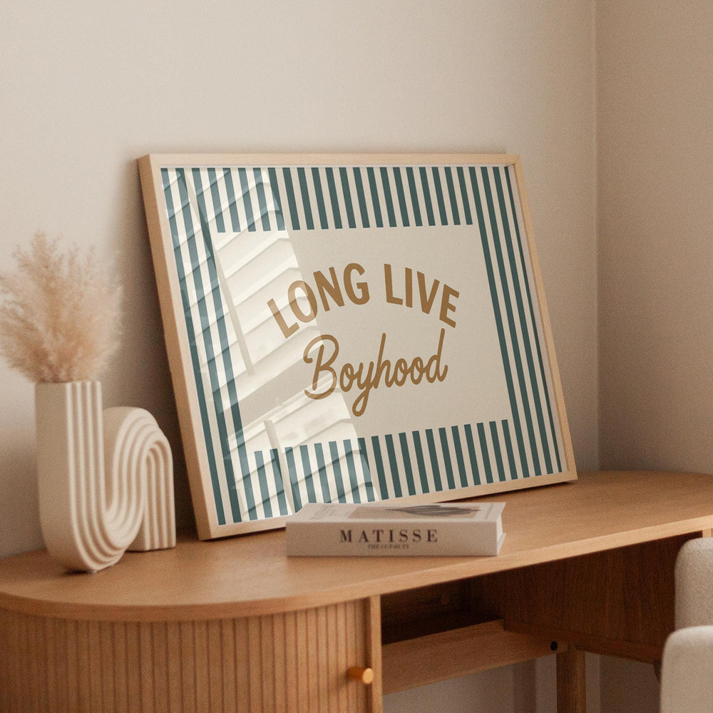 a picture of a long live boyhood sign on a desk