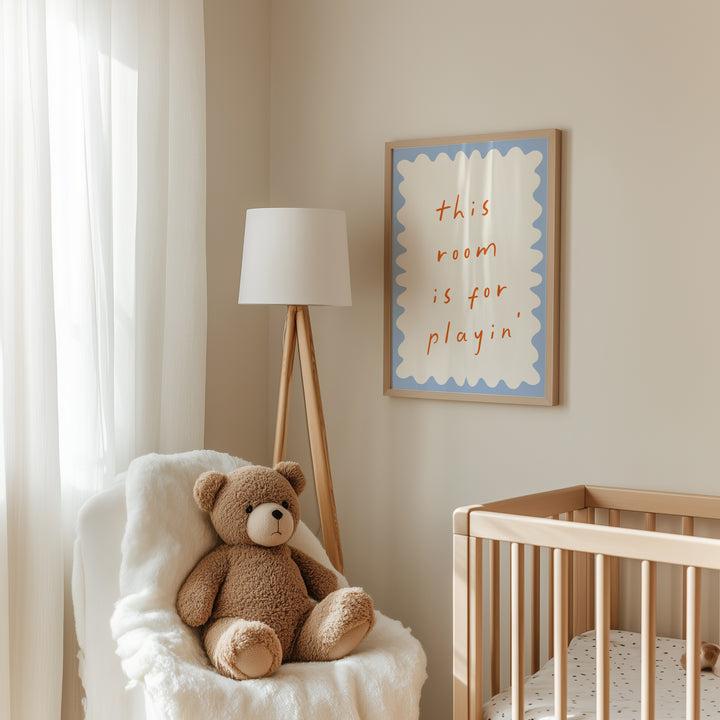 a teddy bear sitting in a chair next to a crib
