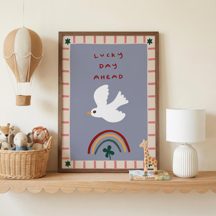a framed poster with a white bird, a rainbow, and a green shamrock, along with a basket of stuffed animals and a lamp on a shelf.