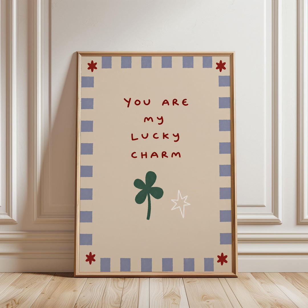 A framed poster with a message that reads "You are my lucky charm" and a clover leaf and star symbol.