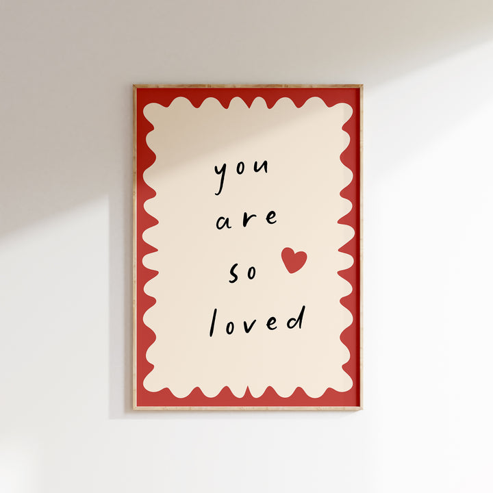 a red and white picture hanging on a wall