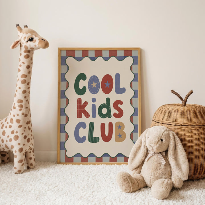 a giraffe and a stuffed rabbit, with a framed sign that reads "Cool Kids Club" in the background.