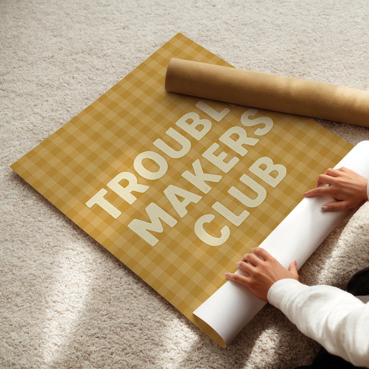 a person laying on the floor with a roll of paper