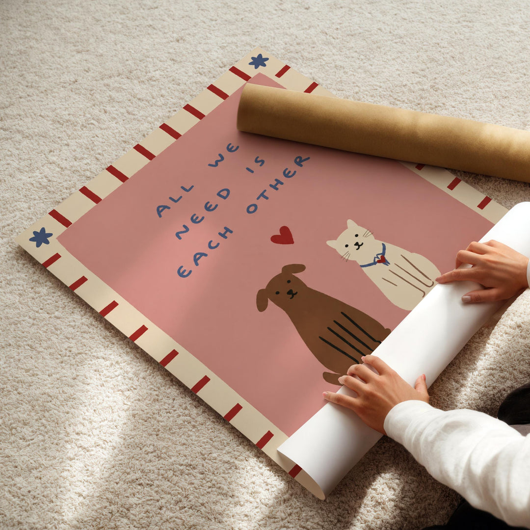 A person's hands are rolling up a poster with a message about the importance of each other.