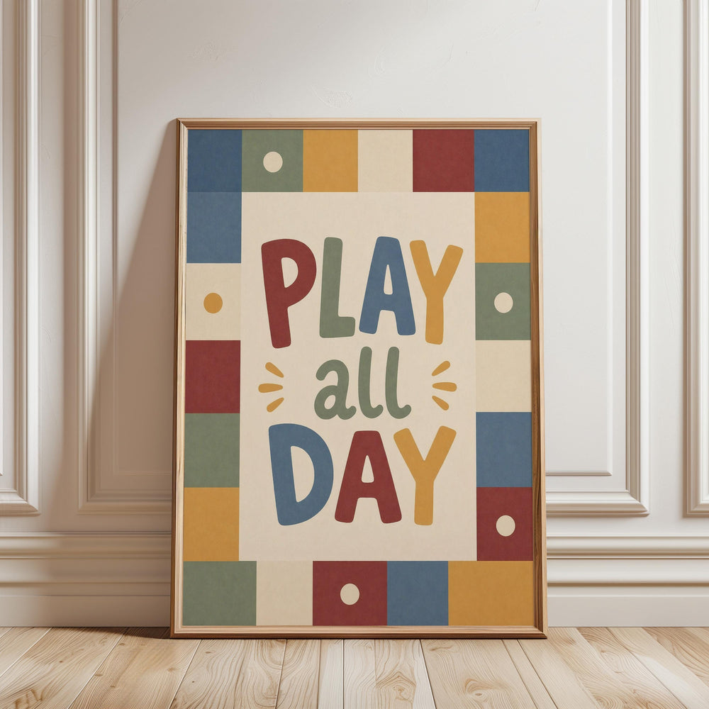 A framed poster with the text "PLAY all DAY" in a colorful, playful font.