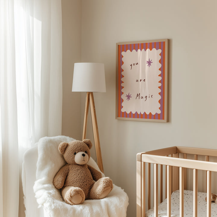 a teddy bear sitting in a chair next to a crib