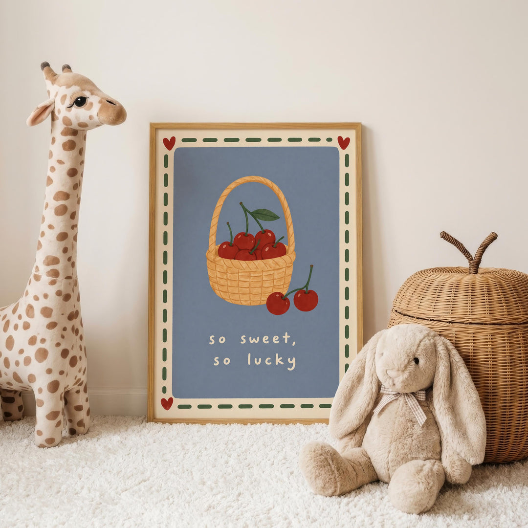 A framed picture of cherries in a basket is displayed on a white wall, accompanied by a stuffed giraffe and a stuffed rabbit.