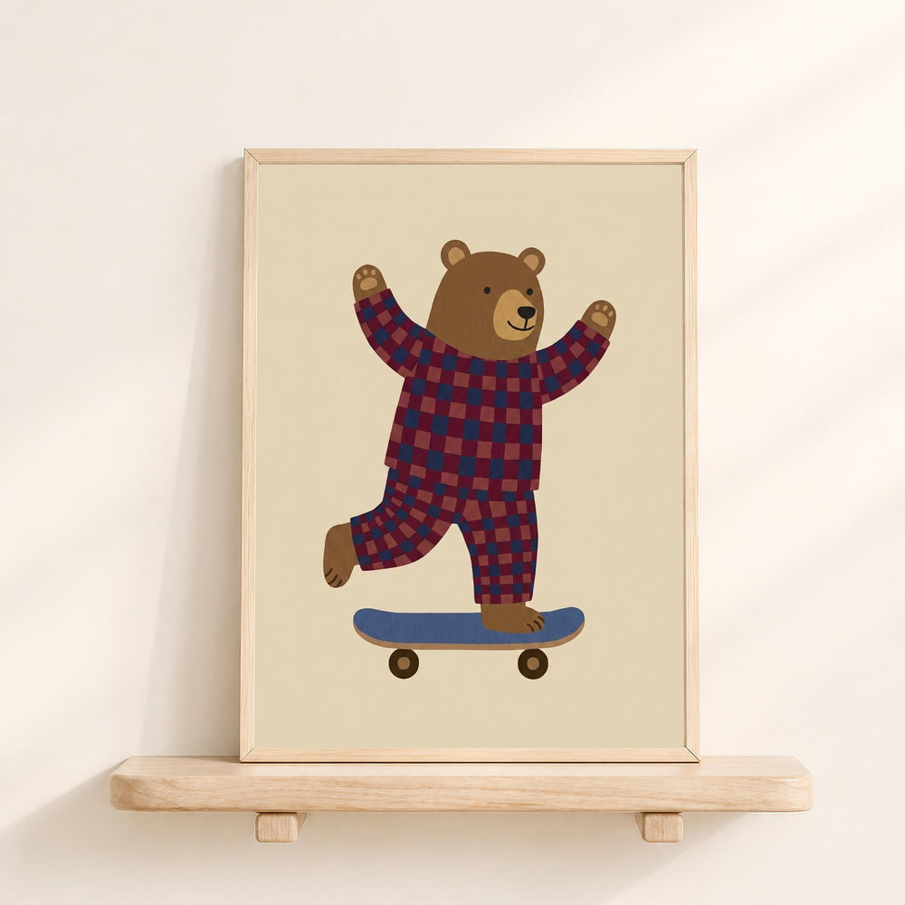 A framed illustration of a bear wearing a checkered outfit and riding a skateboard.