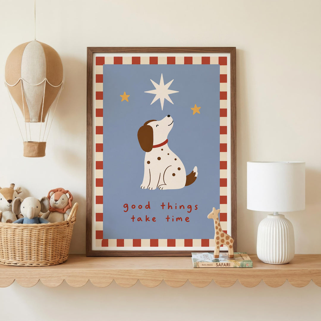 a framed poster with a cartoon dog and a star, placed on a shelf next to a basket of stuffed animals and a lamp.