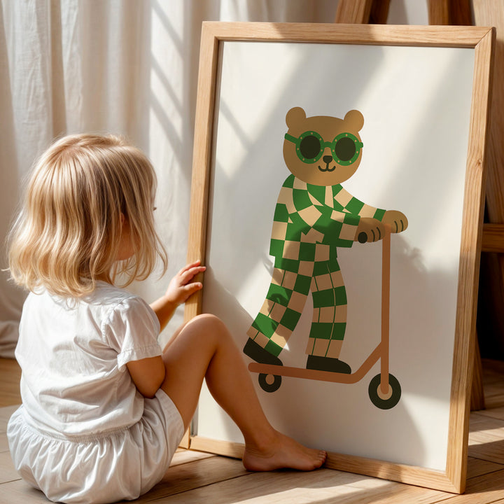 a little girl sitting on the floor next to a picture of a teddy bear