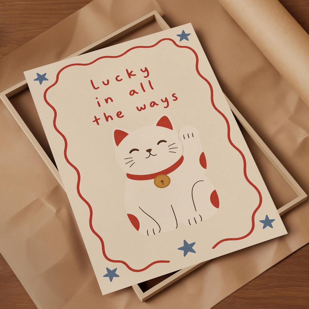 A framed card with a white cat illustration and the text "Lucky in all the ways" written on it.