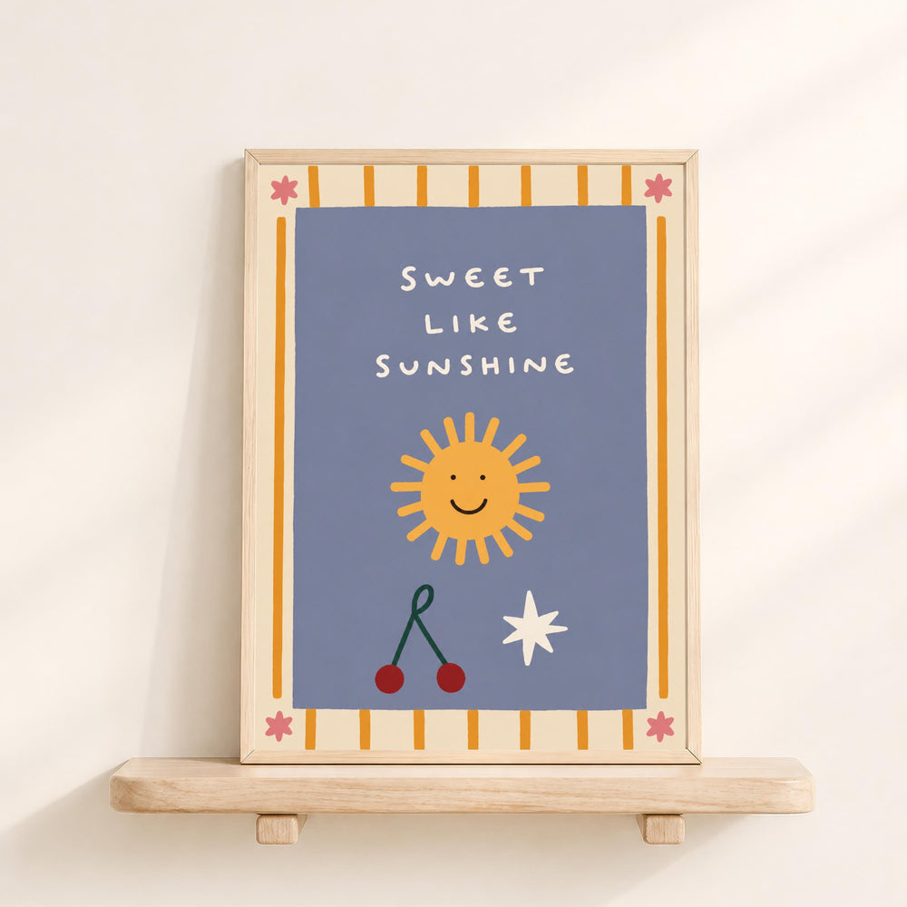 a framed poster with a cheerful design, including a sun, cherries, and a star, along with the text "Sweet like sunshine".