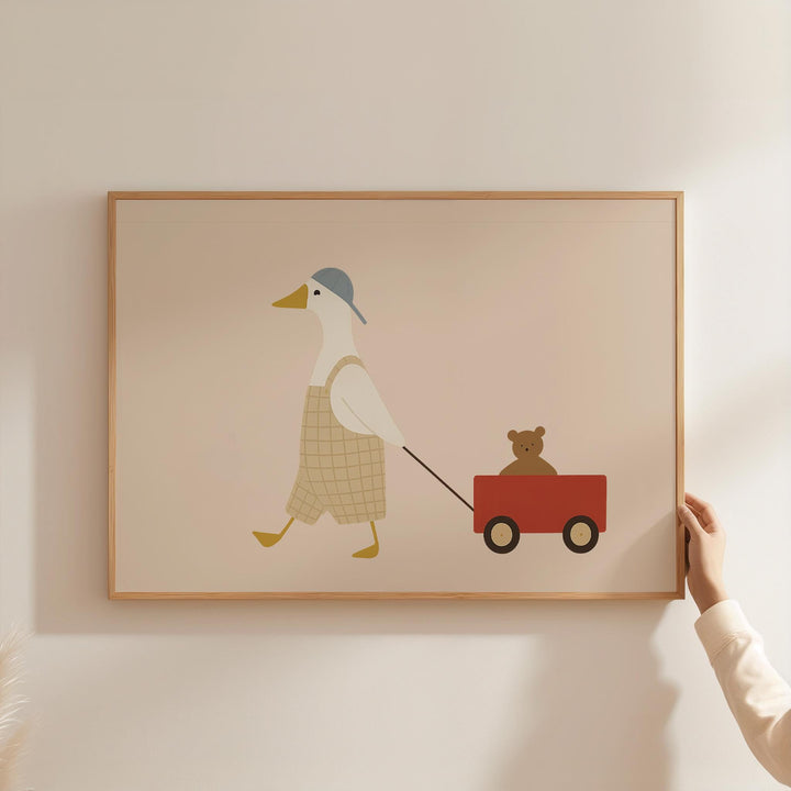 a person holding a picture of a duck pulling a wagon with a teddy bear