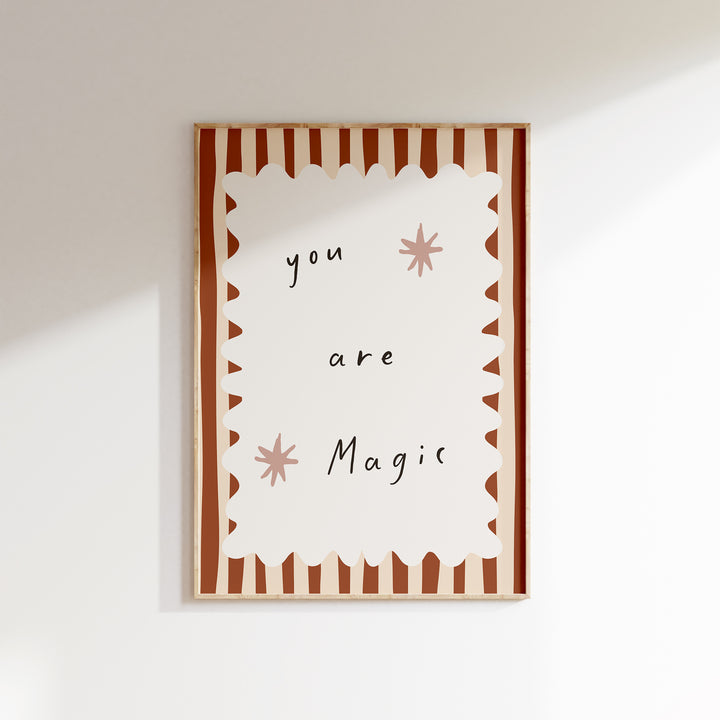 a card that says you are magic hanging on a wall