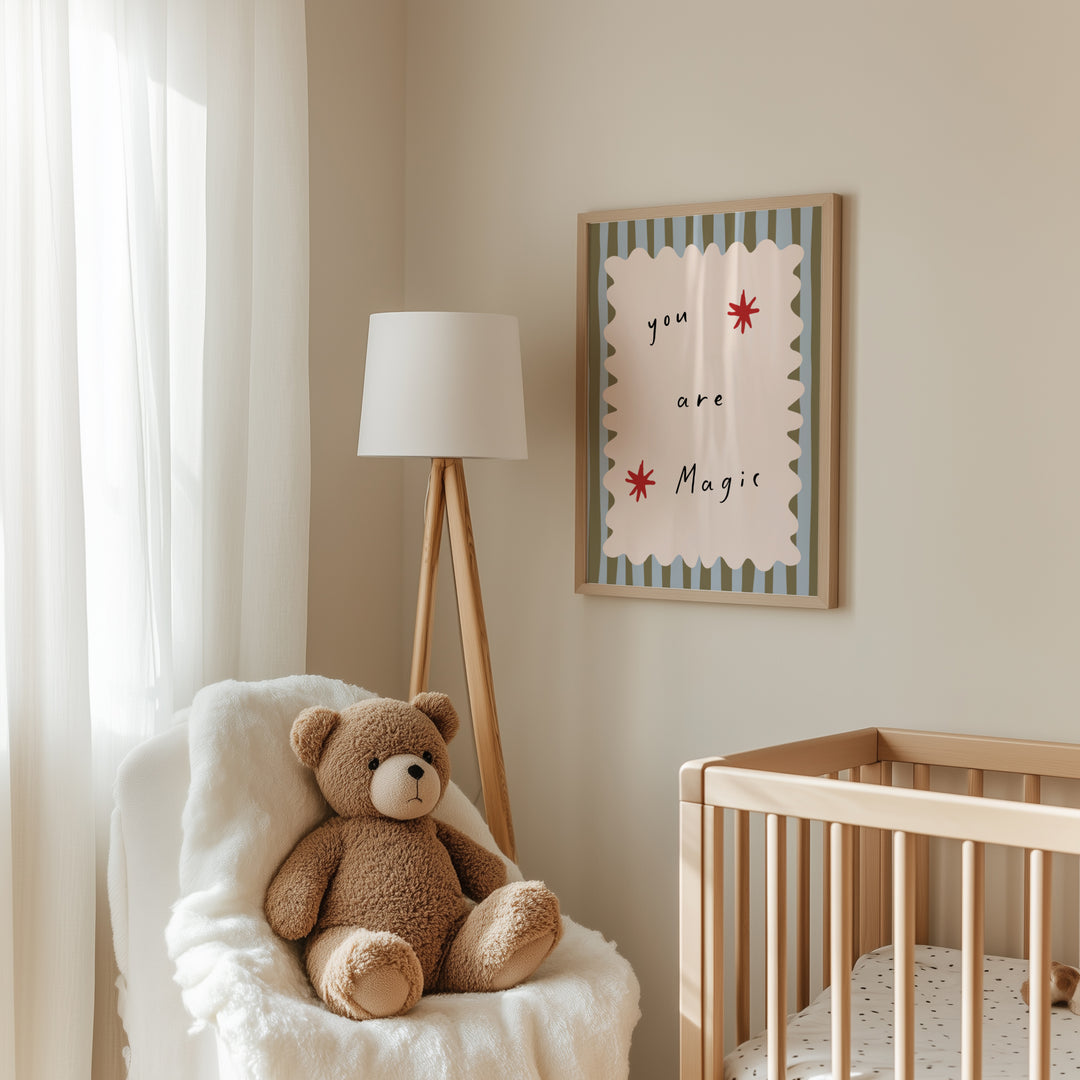 a teddy bear sitting in a chair next to a crib