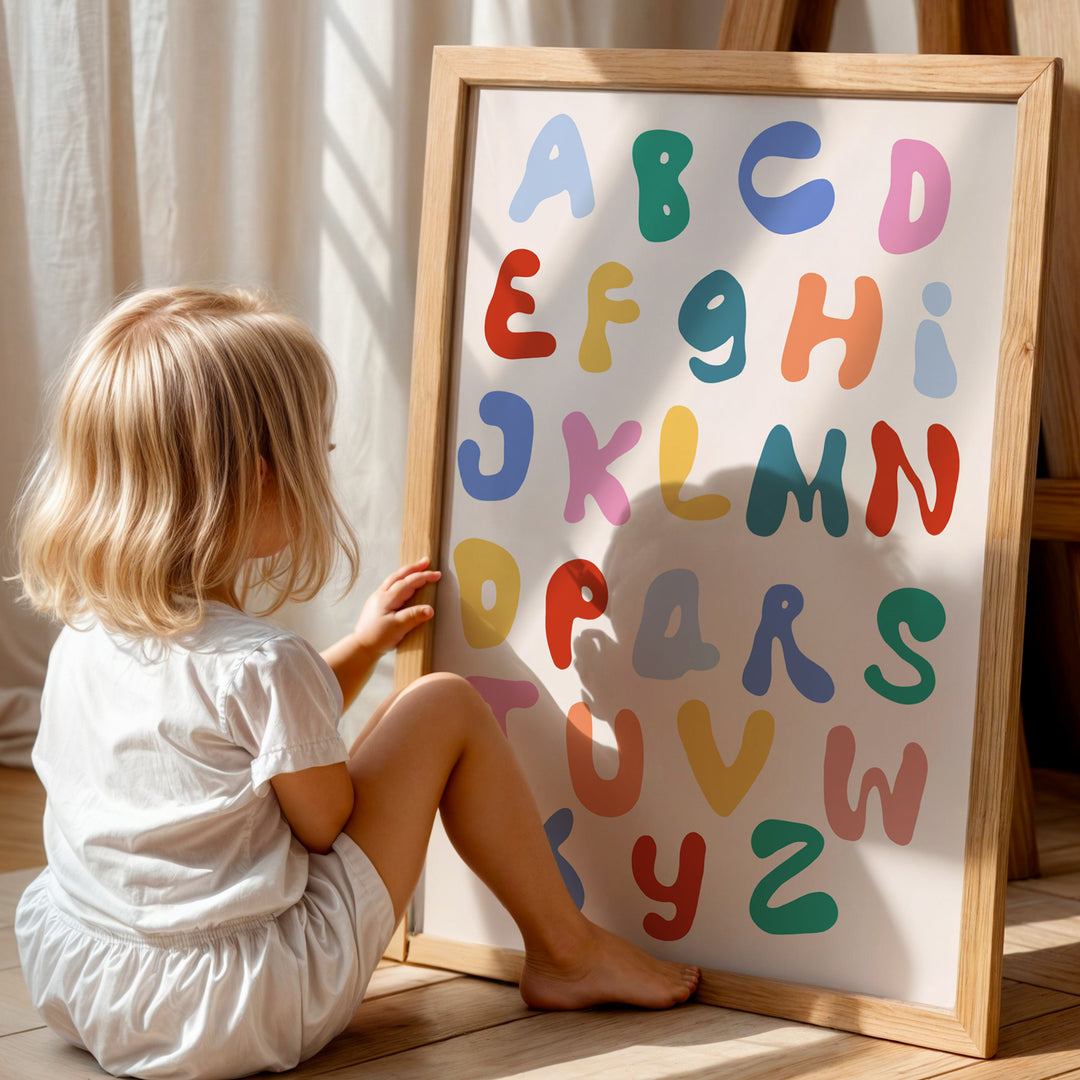 a little girl sitting on the floor next to a sign