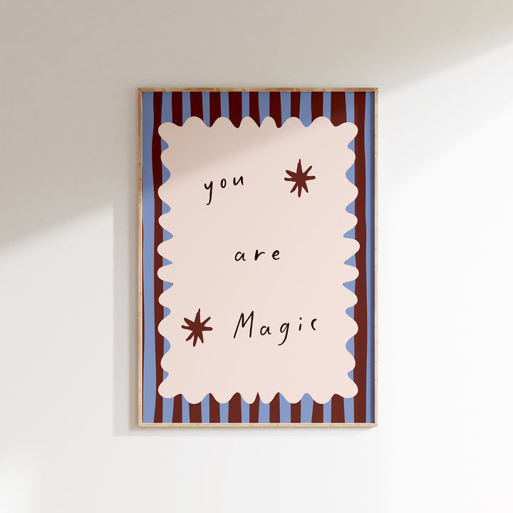 a picture hanging on a wall with the words you are magic