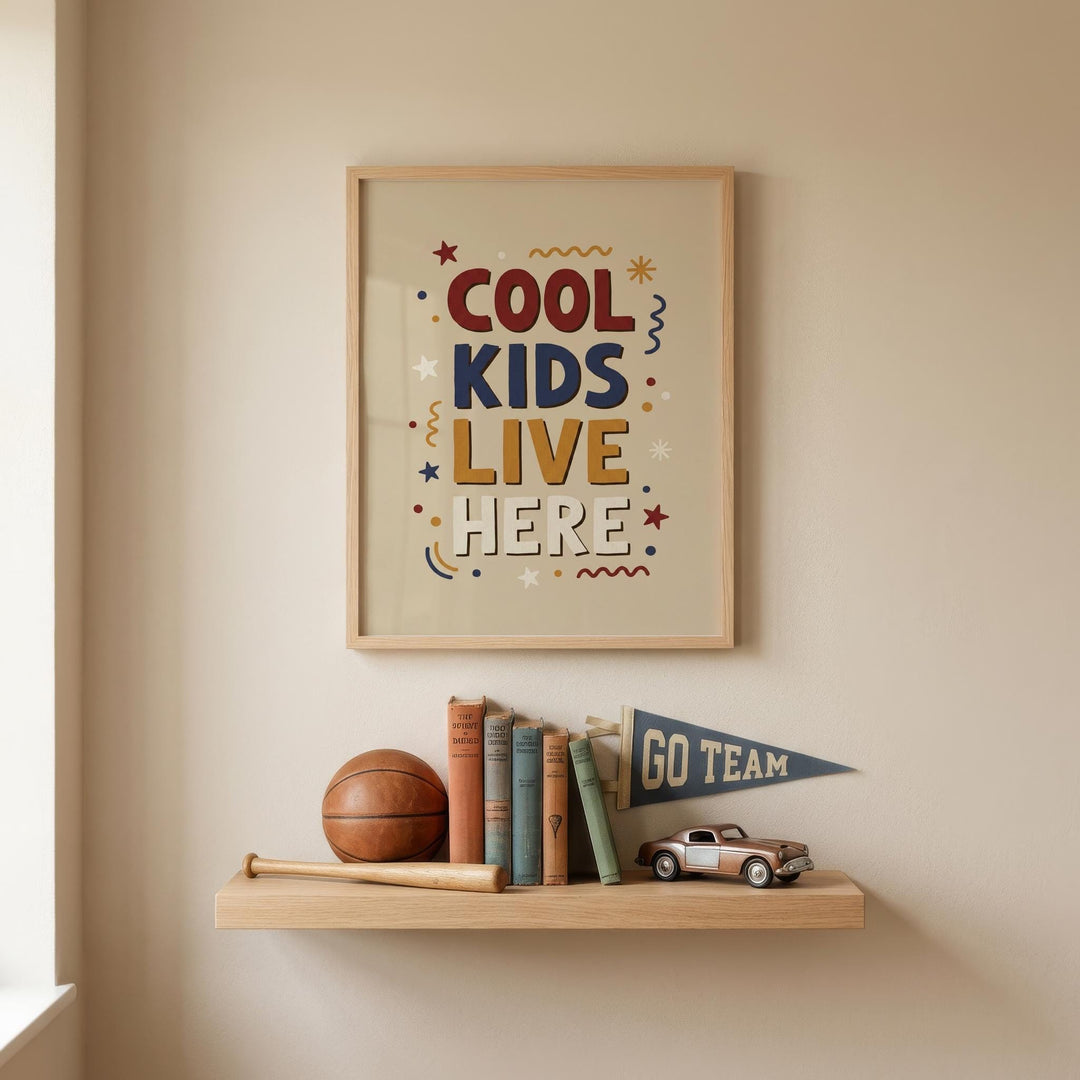 a framed poster with the text "COOL KIDS LIVE HERE" and a small flag that says "GO TEAM" on a shelf below it. The shelf also holds a basketball, baseball bat, and a collection of books.