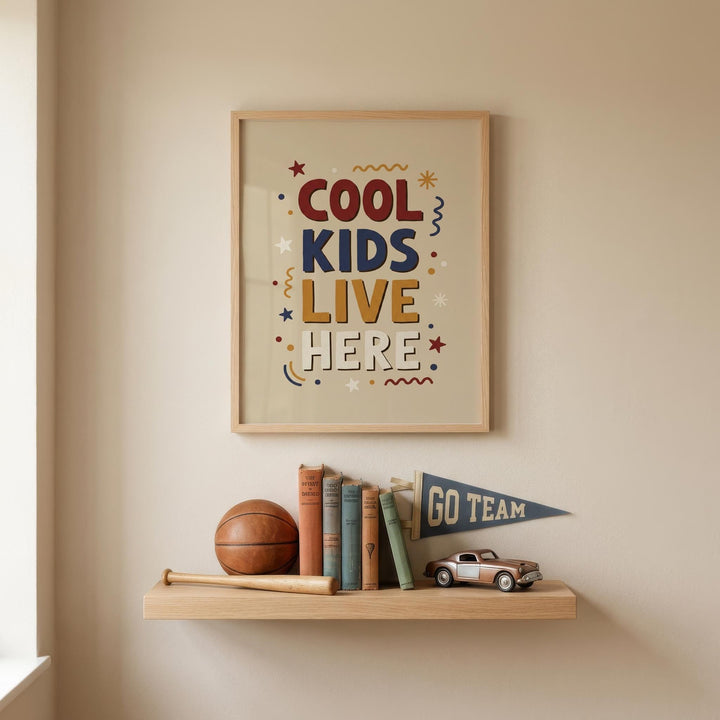a framed poster with the text "COOL KIDS LIVE HERE" and a small flag that says "GO TEAM" on a shelf below it. The shelf also holds a basketball, baseball bat, and a collection of books.