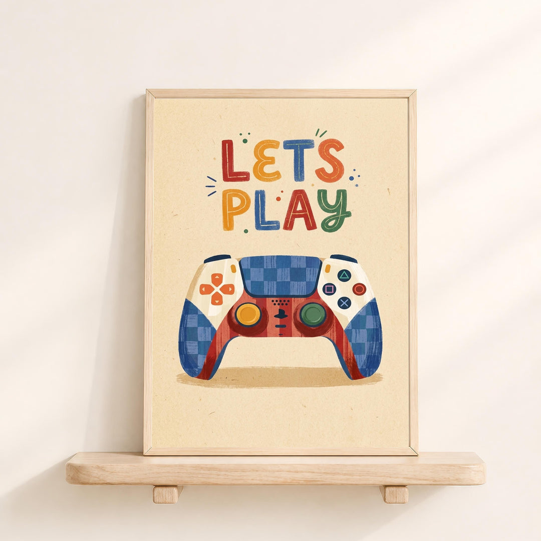 A framed poster with a colorful illustration of a game controller and the text "LET'S PLAY" written on it.