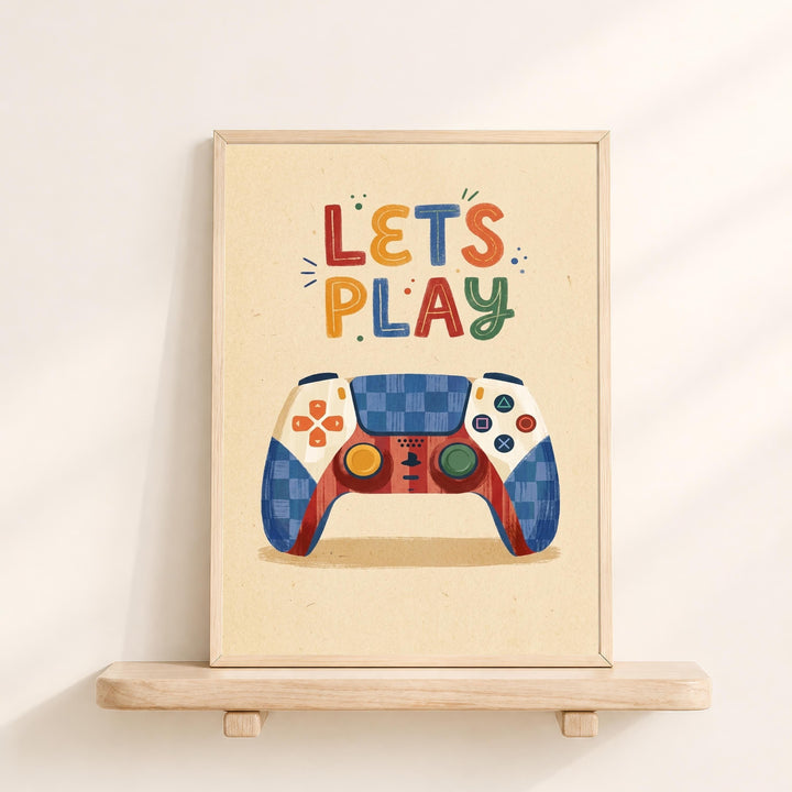 A framed poster with a colorful illustration of a game controller and the text "LET'S PLAY" written on it.