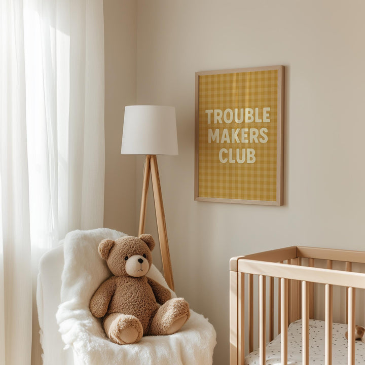 a teddy bear sitting in a chair next to a crib