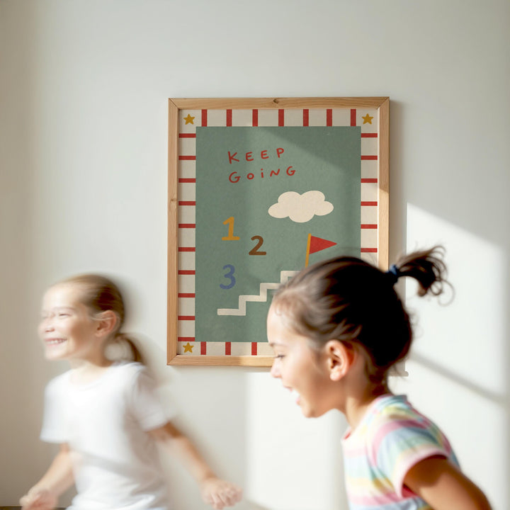 Two young girls are running in front of a colorful poster with the words "KEEP GOING" and a cloud, along with numbers 1, 2, and 3.