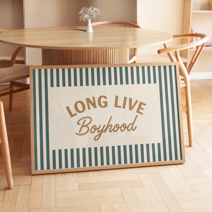 a long live boyhood sign sitting in front of a table