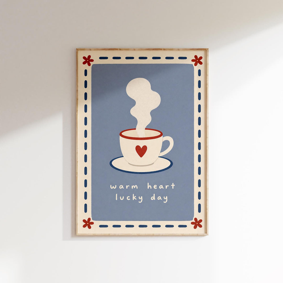 A framed illustration of a steaming cup of coffee with a heart symbol, accompanied by the text "Warm heart lucky day" in a decorative border.