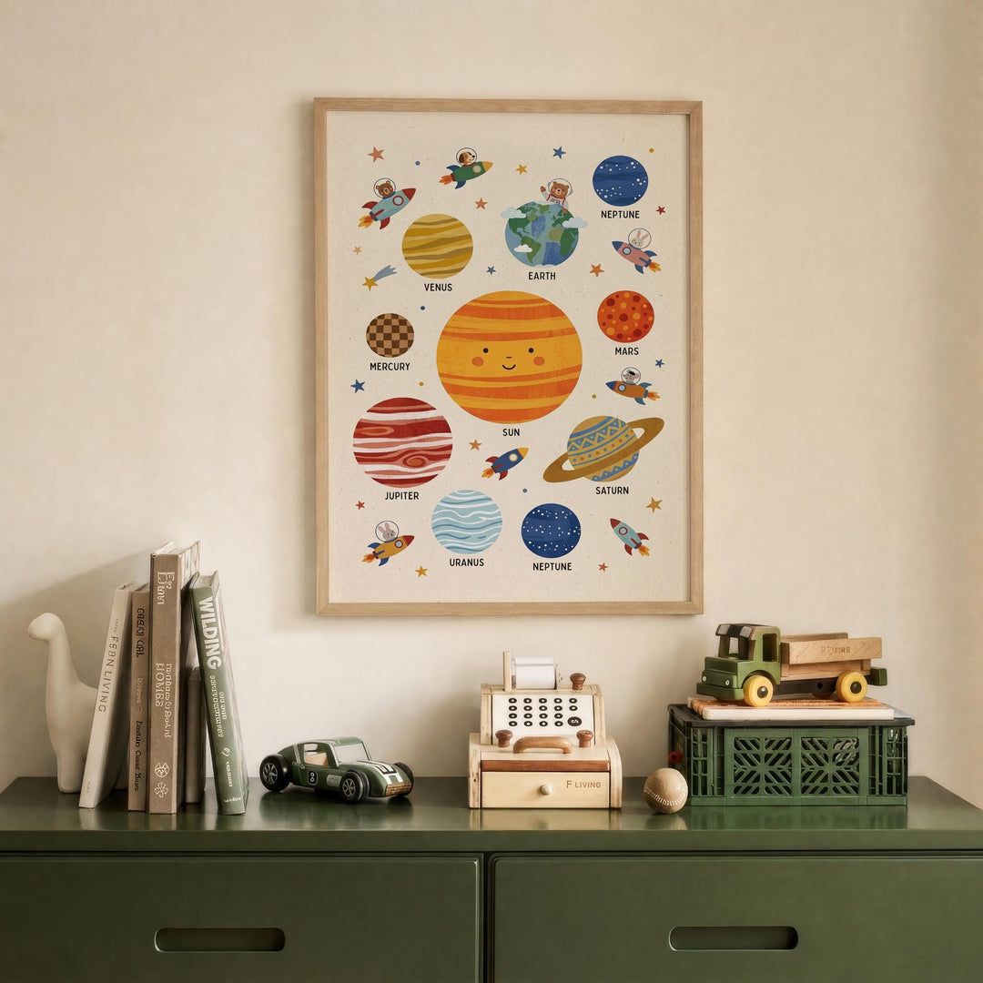 a framed poster of the solar system hanging on a wall above a green dresser. The poster displays various planets and their names, such as Mercury, Venus, Earth, Mars, Jupiter, Saturn, Neptune, and Uranus. The dresser has a toy car and a toy truck on it, along with some books.