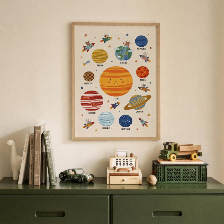 a framed poster of the solar system hanging on a wall above a green dresser. The poster displays various planets and their names, such as Mercury, Venus, Earth, Mars, Jupiter, Saturn, Neptune, and Uranus. The dresser has a toy car and a toy truck on it, along with some books.