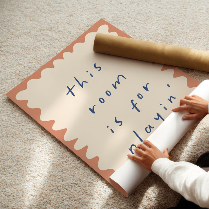 a child is holding a rolled up paper and a rolled up sign