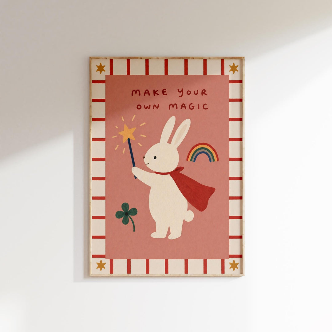 The image is a framed poster with a cartoon rabbit holding a wand and a rainbow, accompanied by the text "MAKE YOUR OWN MAGIC".