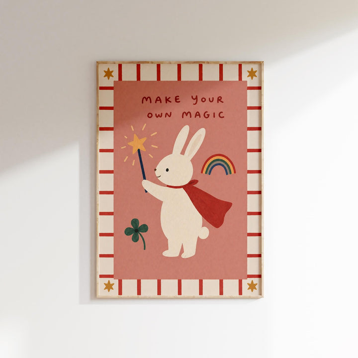 The image is a framed poster with a cartoon rabbit holding a wand and a rainbow, accompanied by the text "MAKE YOUR OWN MAGIC".