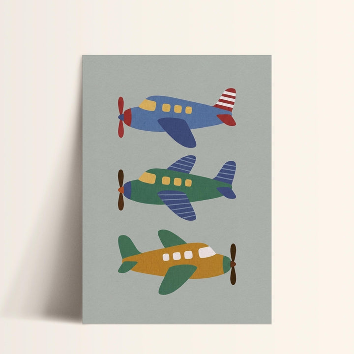 A collage of three colorful airplanes in different positions, with a gray background.