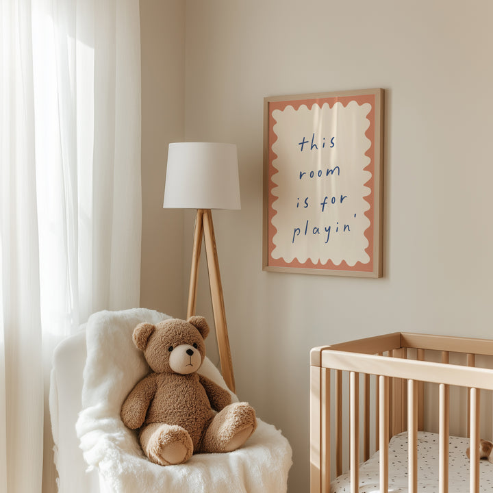 a teddy bear sitting in a chair next to a crib