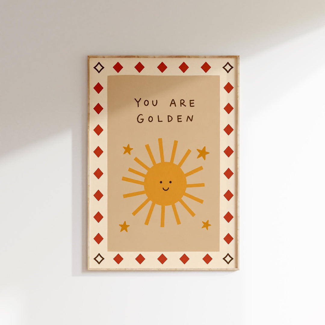 The image is a framed poster with a cheerful sun and stars design, along with the text "You are Golden" written on it.