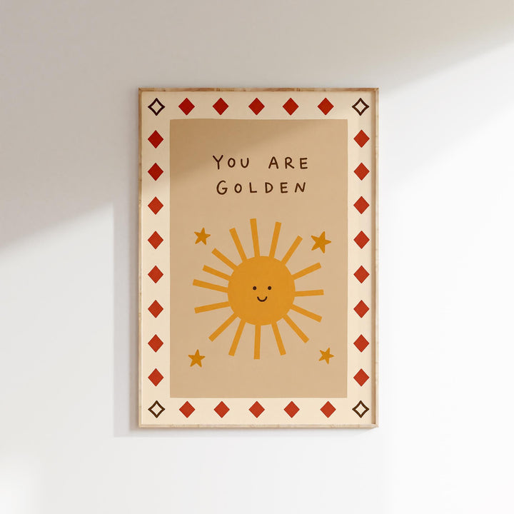 The image is a framed poster with a cheerful sun and stars design, along with the text "You are Golden" written on it.