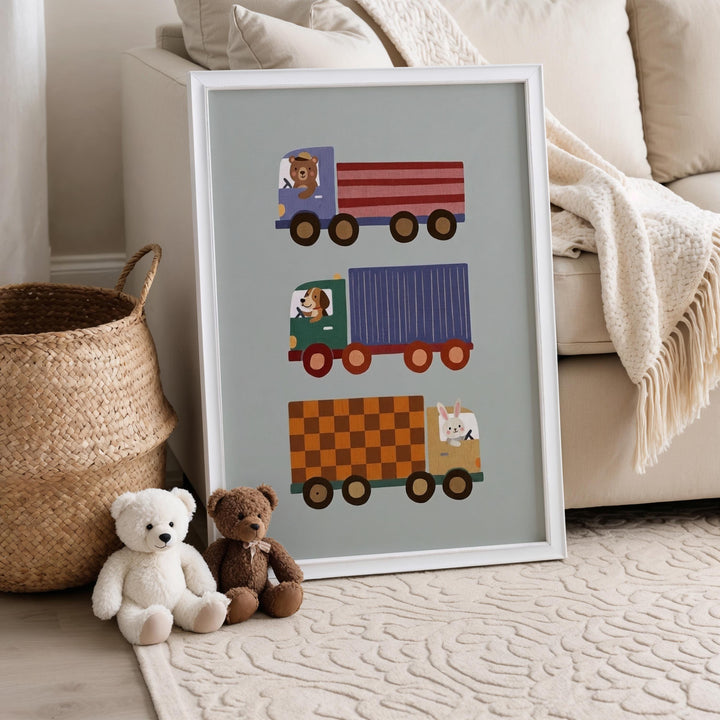 a framed poster of three colorful trucks with illustrations of a dog and two teddy bears sitting next to the trucks.