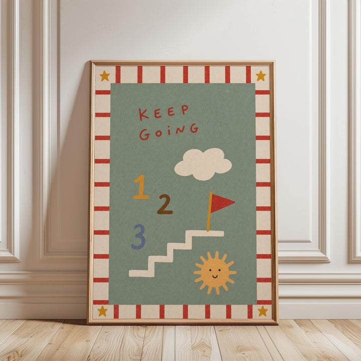 The image is a framed poster with a colorful design featuring a cloud, a flag, and a sun. The poster has a motivational message that reads "KEEP GOING" and includes numbers 1, 2, and 3.